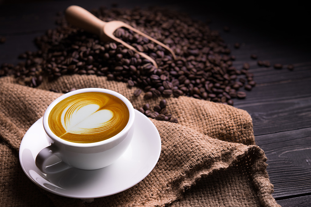 fresh coffee beans and coffee cup